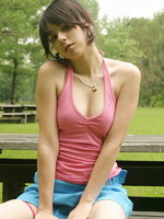 sexy teen sits at the park